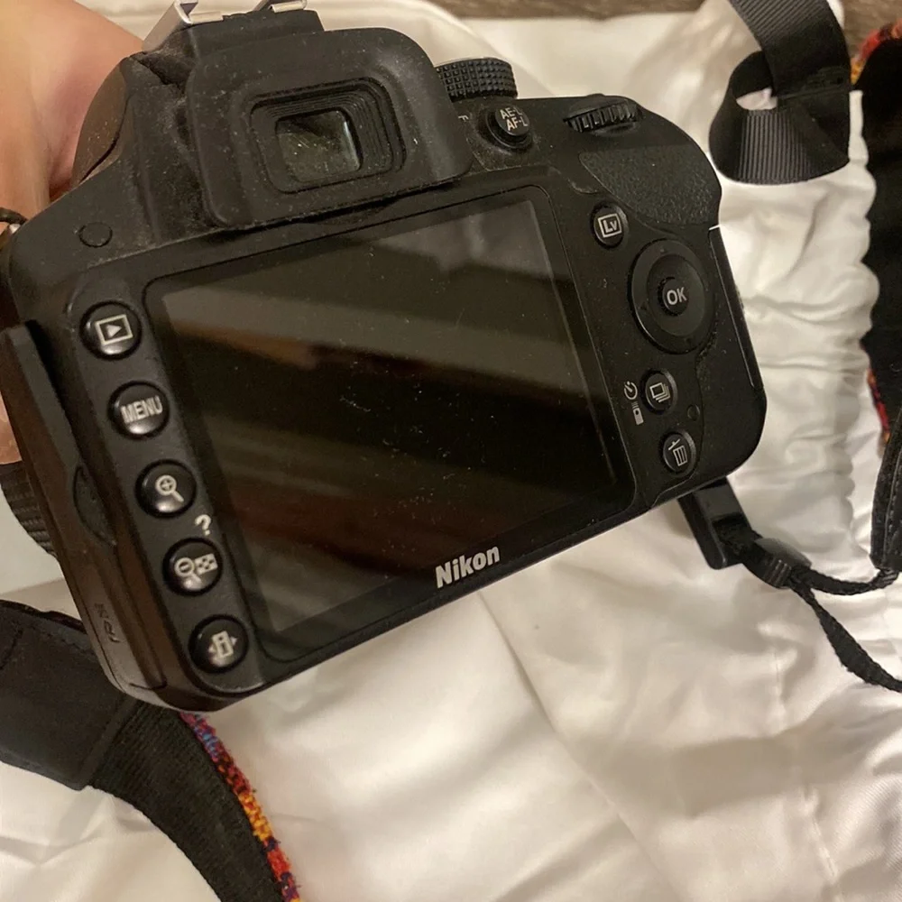 Nikon D3200 camera with battery pack and 55-200 mm lense